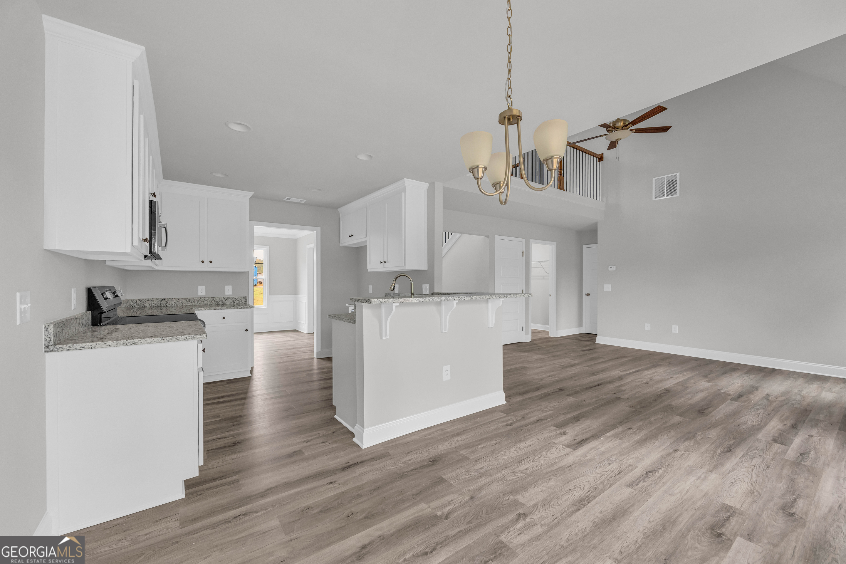152 Sewell Road Lavonia, GA 30553 - Photo 14 of 60 a kitchen with kitchen island white cabinets and stainless steel appliances