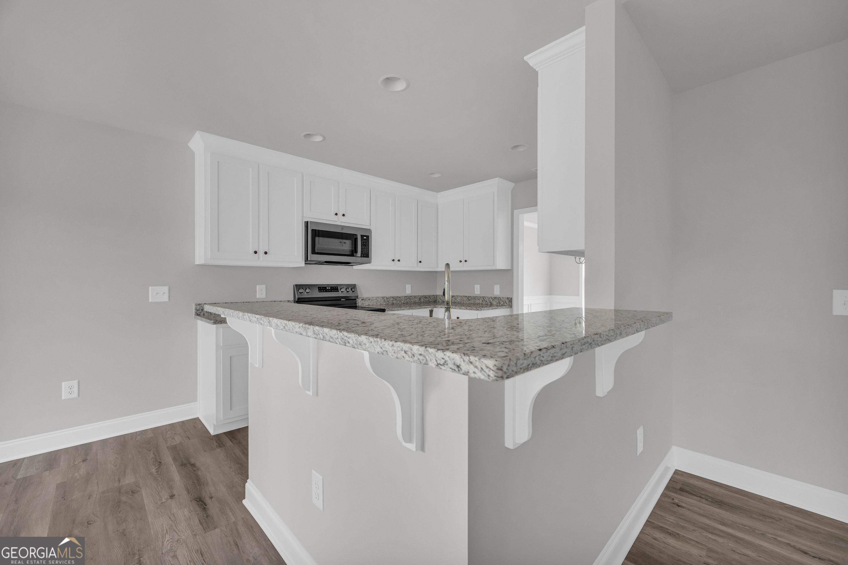 152 Sewell Road Lavonia, GA 30553 - Photo 15 of 60 a kitchen with stainless steel appliances granite countertop a stove a sink and a microwave