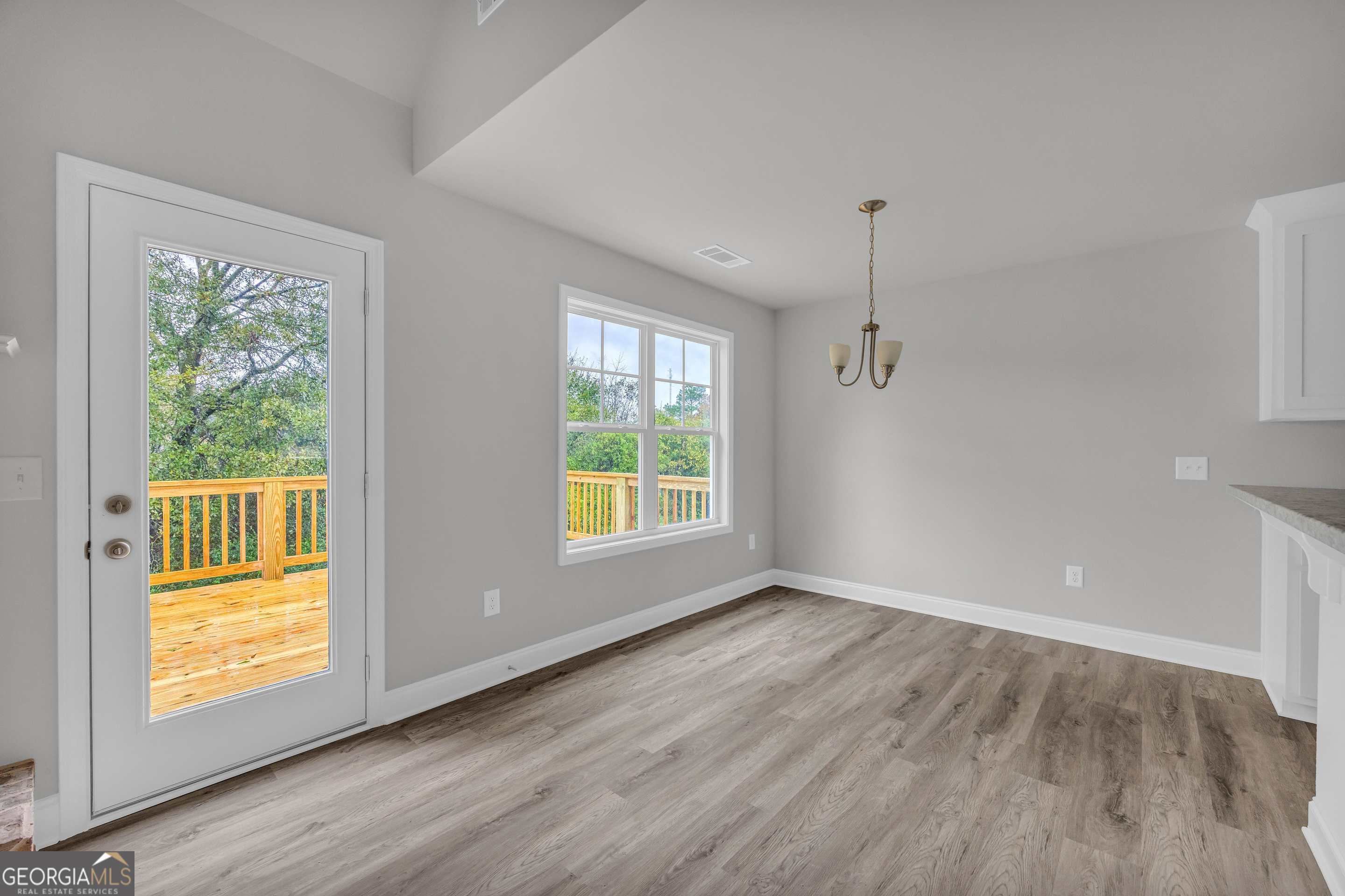 152 Sewell Road Lavonia, GA 30553 - Photo 16 of 60 a view of an empty room with a window and wooden floor