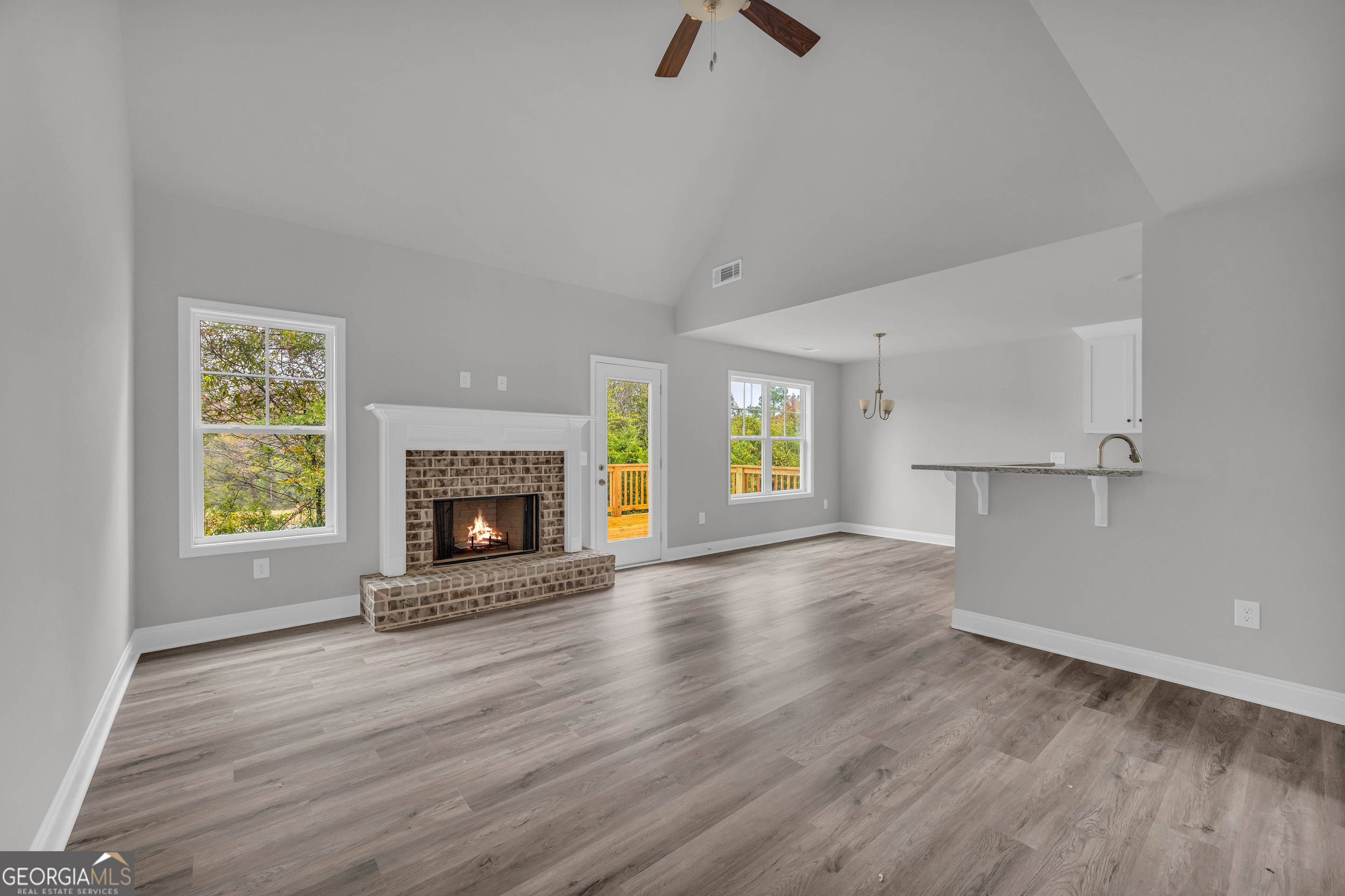 152 Sewell Road Lavonia, GA 30553 - Photo 17 of 60 an empty room with windows a fireplace and wooden floor