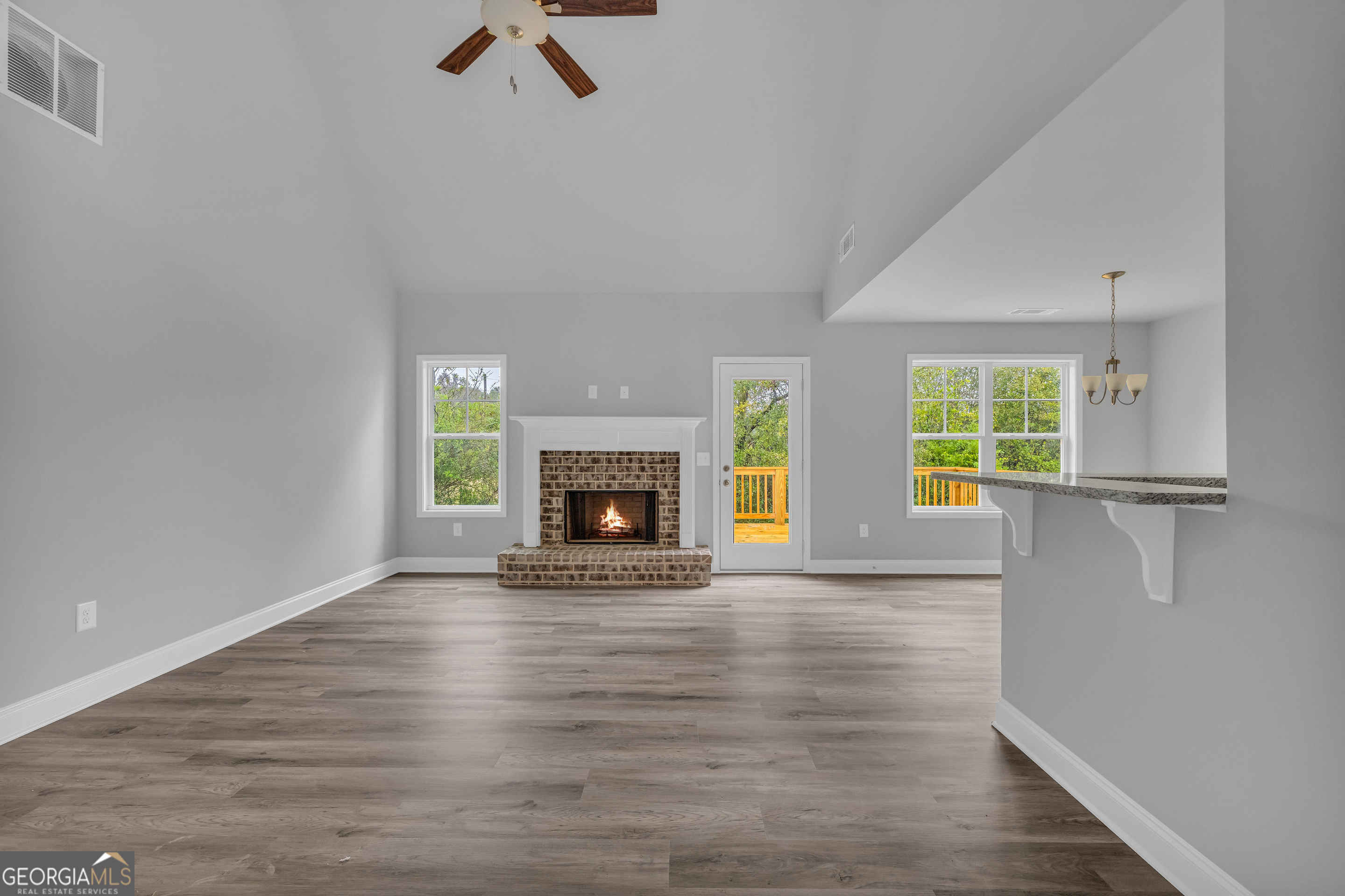 152 Sewell Road Lavonia, GA 30553 - Photo 18 of 60 an empty room with windows a fireplace
