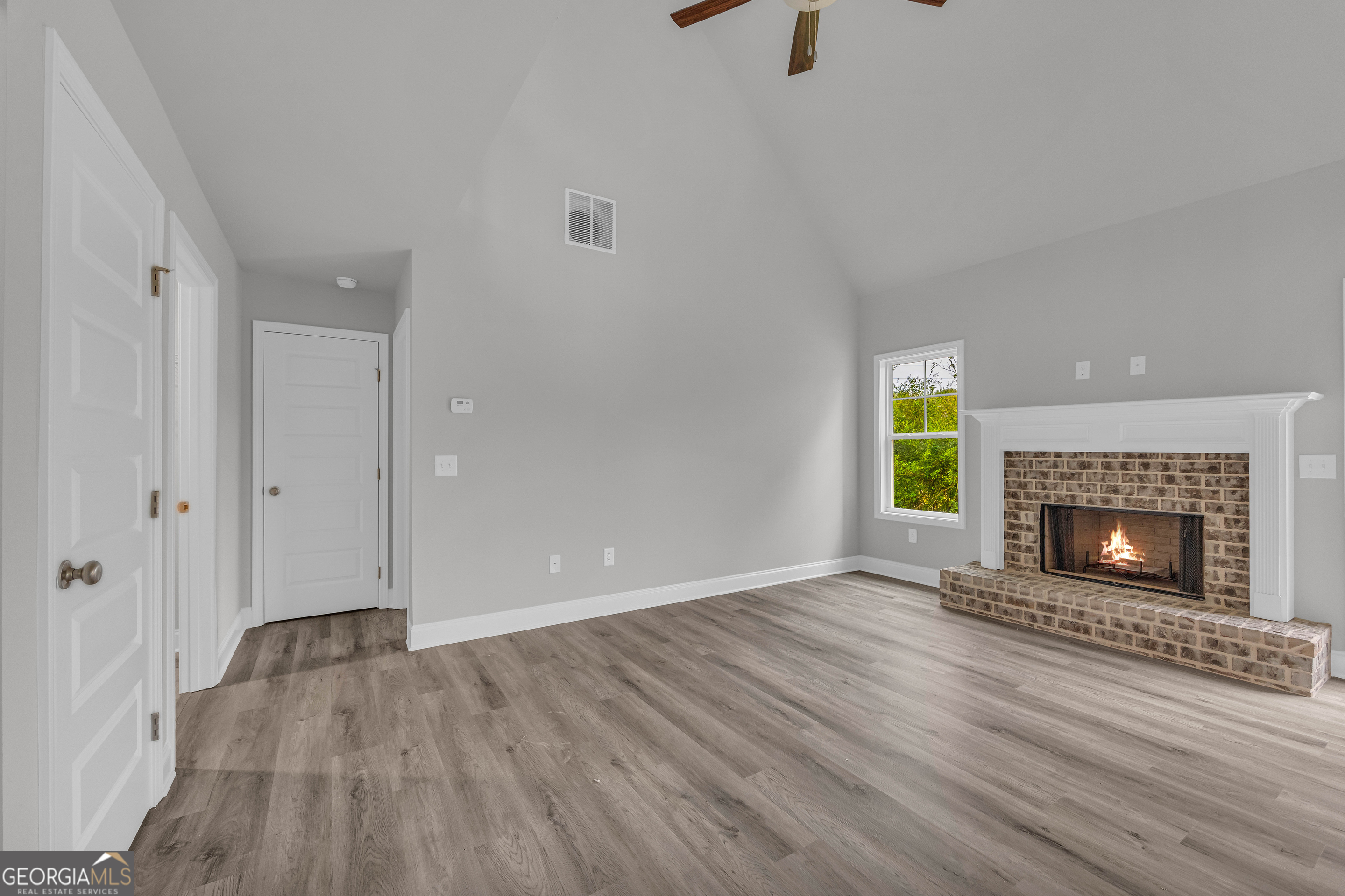 152 Sewell Road Lavonia, GA 30553 - Photo 19 of 60 a view of an empty room with a fireplace and a window