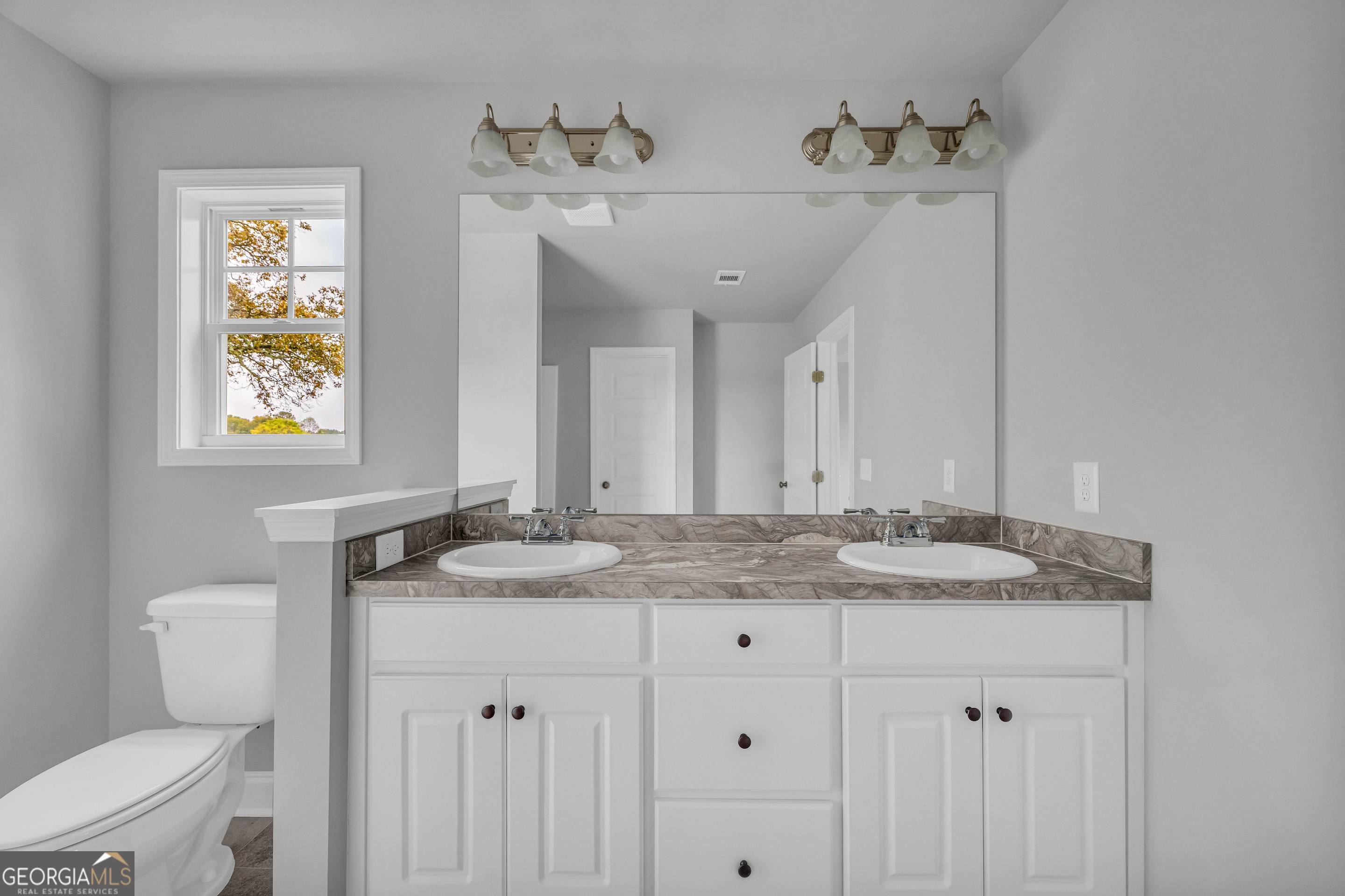152 Sewell Road Lavonia, GA 30553 - Photo 28 of 60 a bathroom with a granite countertop sink and a mirror