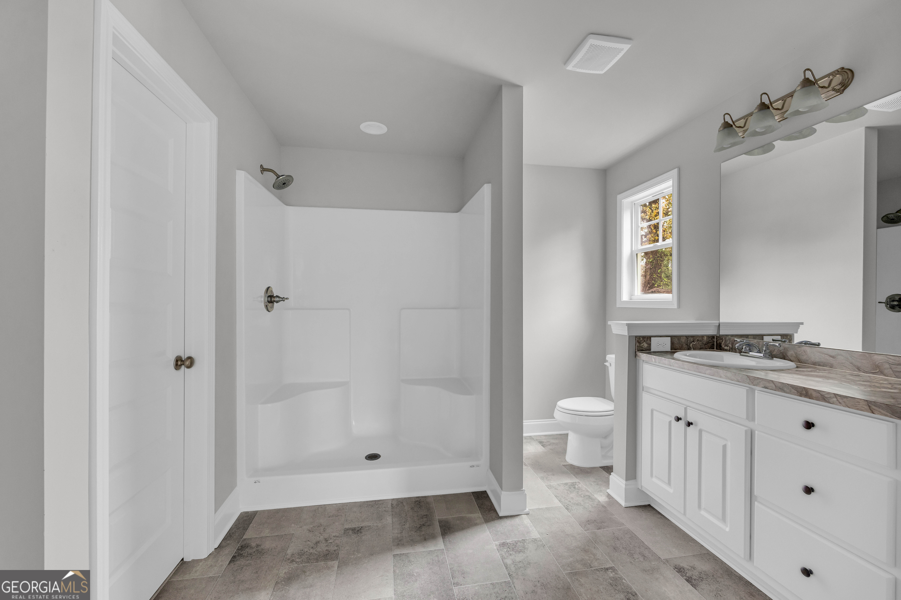 152 Sewell Road Lavonia, GA 30553 - Photo 29 of 60 a bathroom with a granite countertop sink a toilet and shower