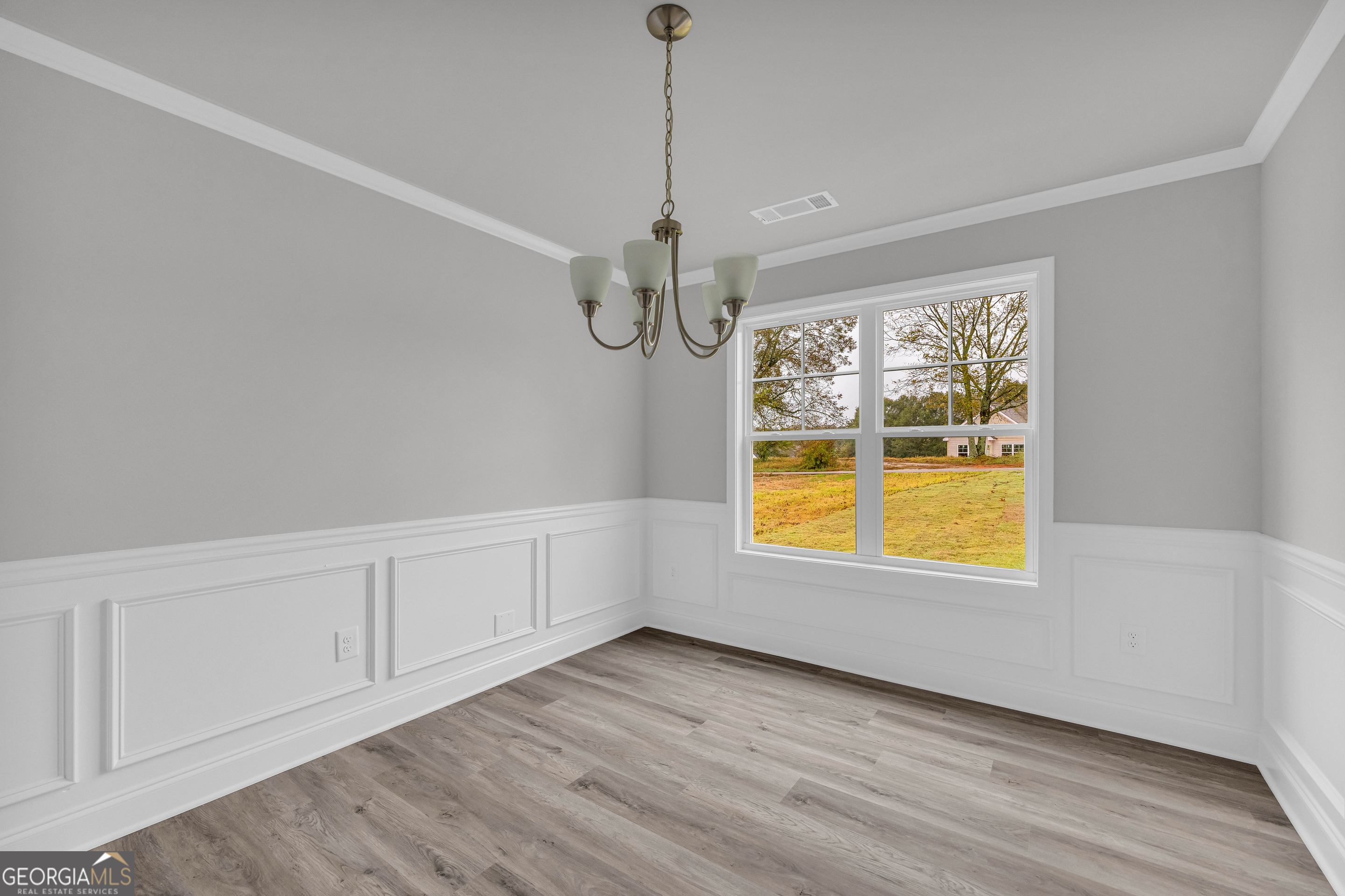 152 Sewell Road Lavonia, GA 30553 - Photo 5 of 60 a view of an empty room with a window and wooden floor