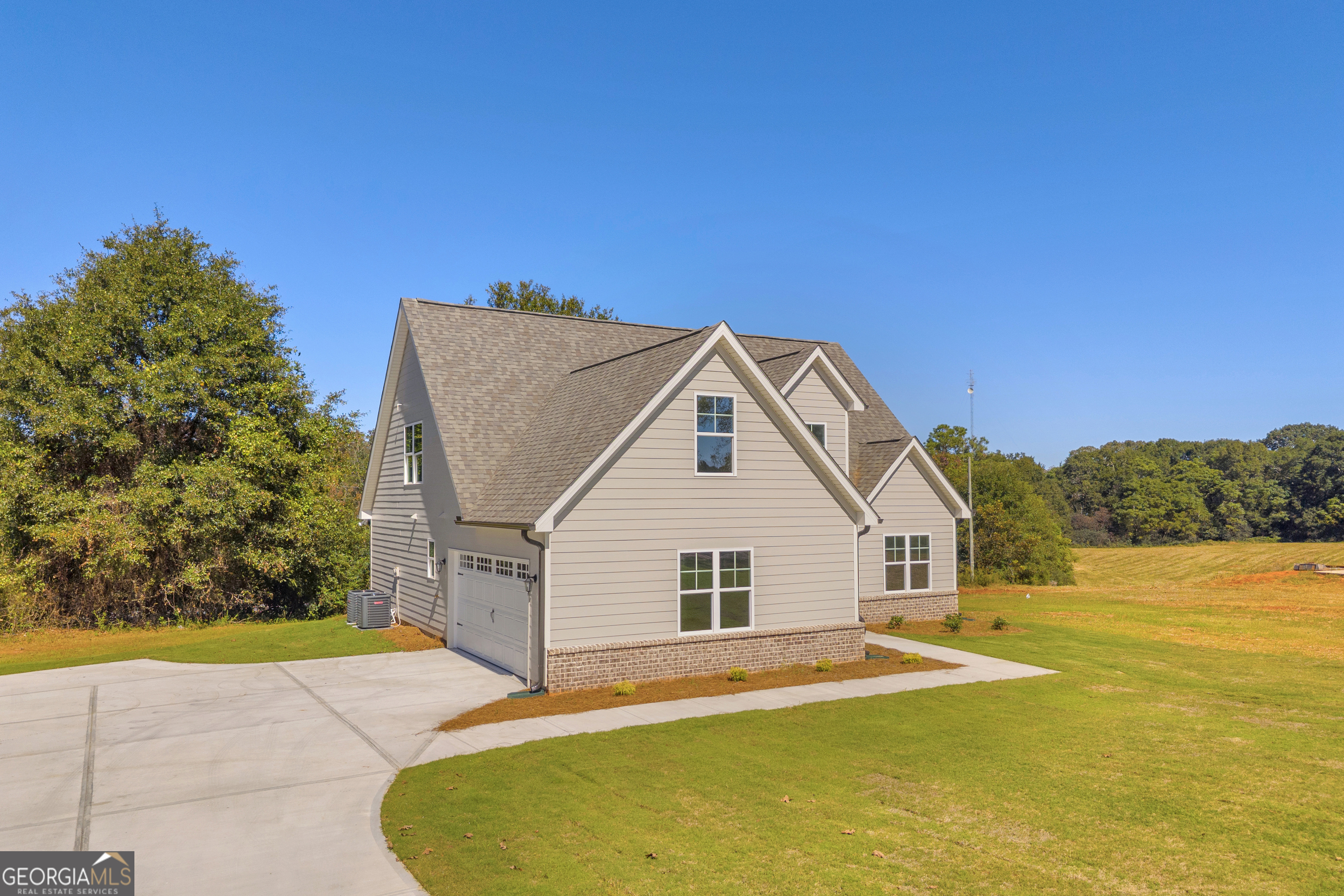 152 Sewell Road Lavonia, GA 30553 - Photo 54 of 60 a view of a white house with a yard and large tree