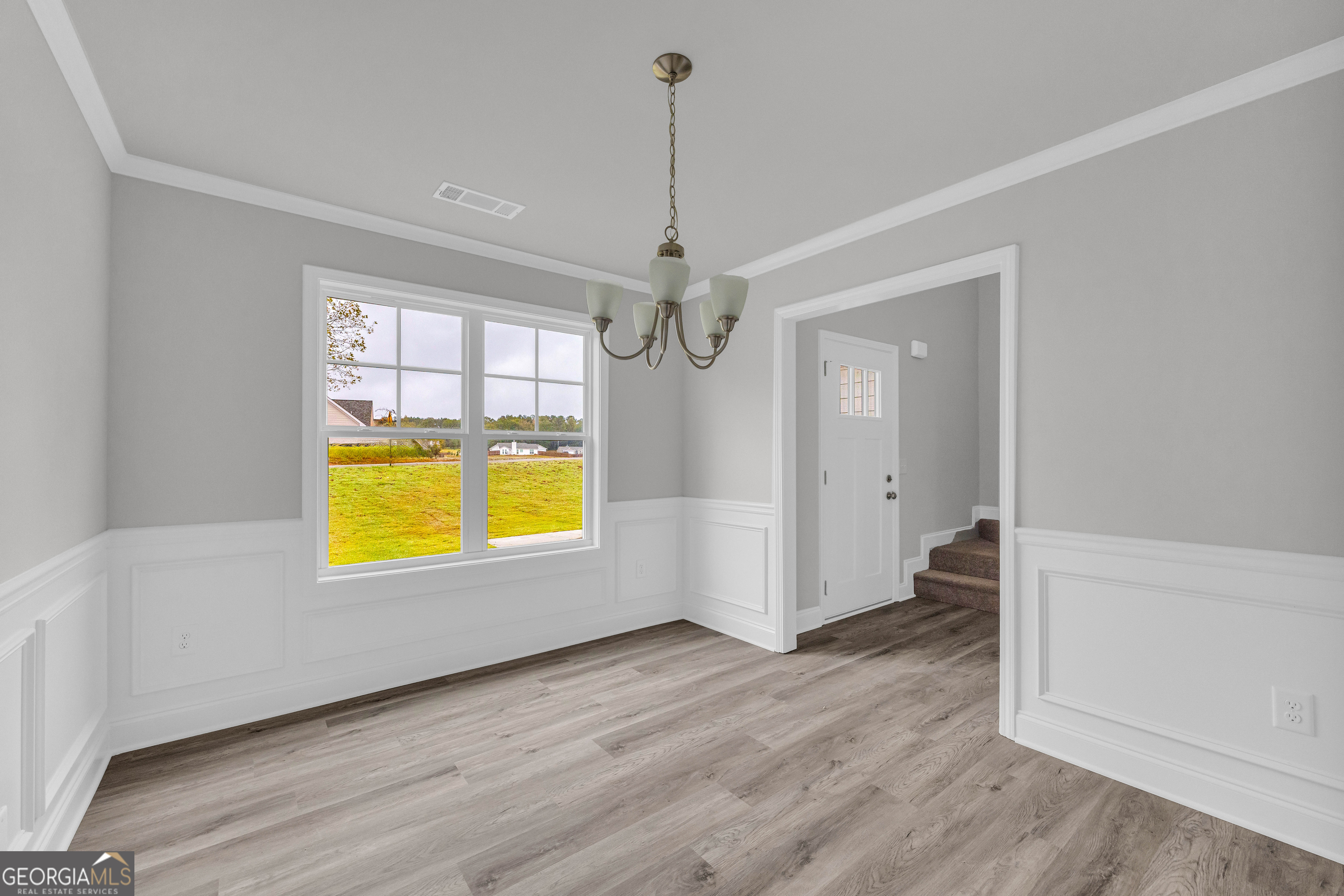 152 Sewell Road Lavonia, GA 30553 - Photo 6 of 60 an empty room with a window and wooden floor
