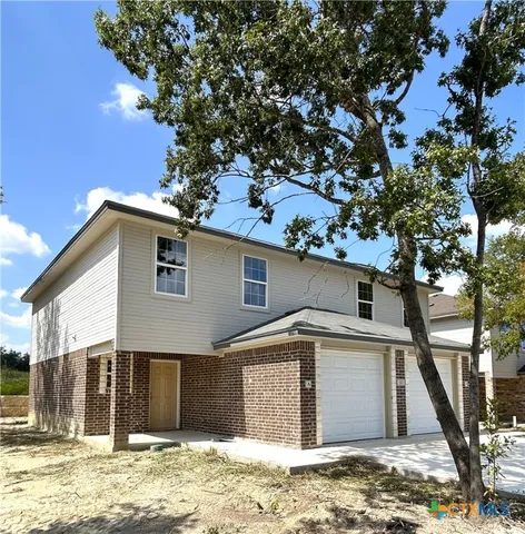 a view of a house with a tree