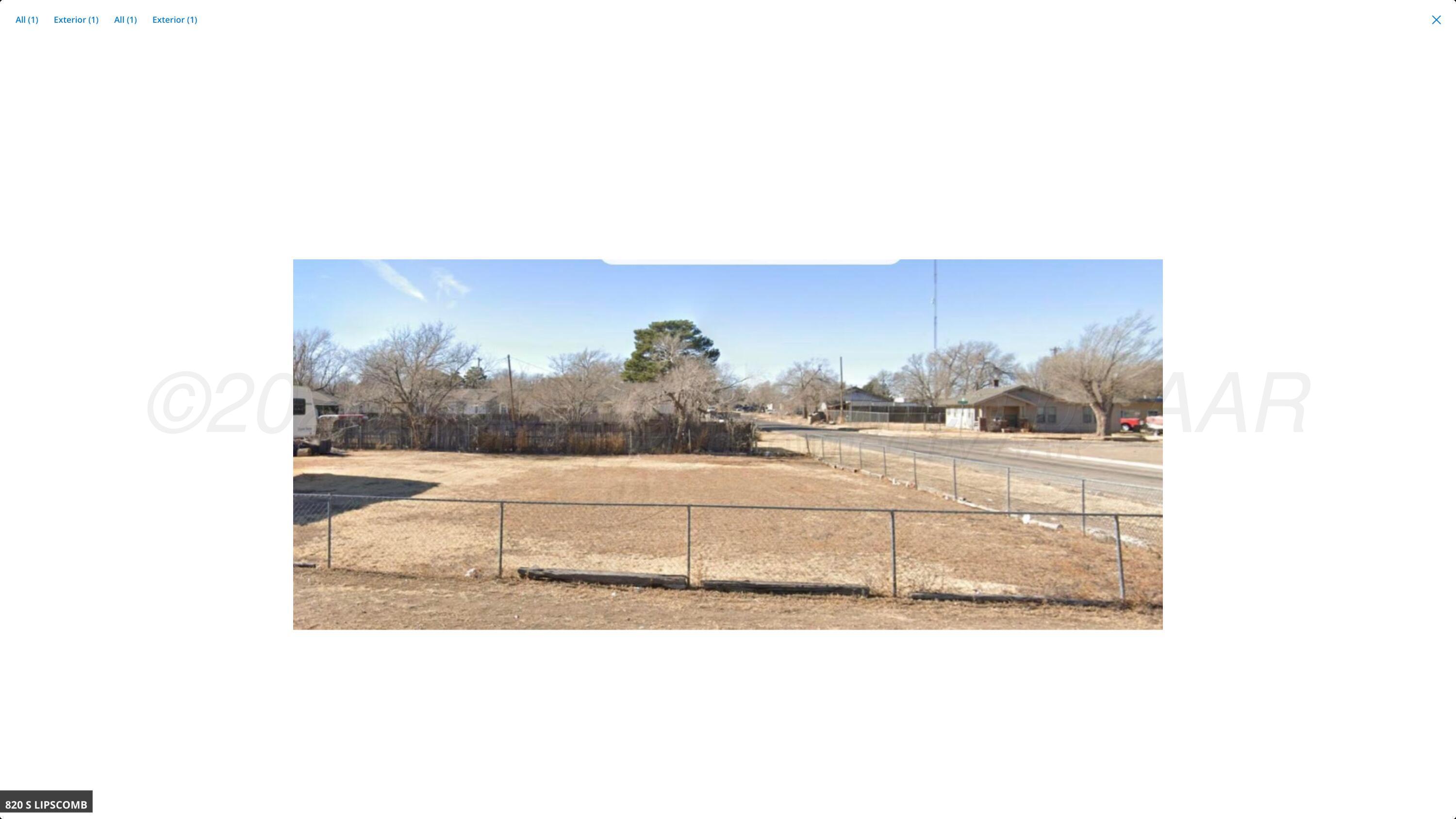 a view of a living room with a bed and a bookshelf