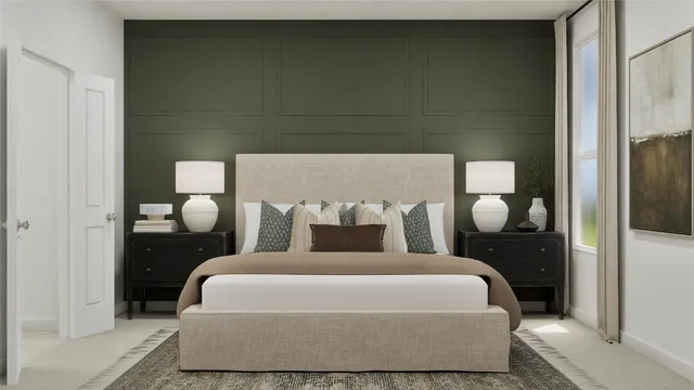 a bed sitting in a bedroom next to a bathroom