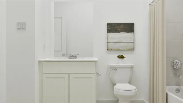 a bathroom with a toilet a sink a mirror and a shower