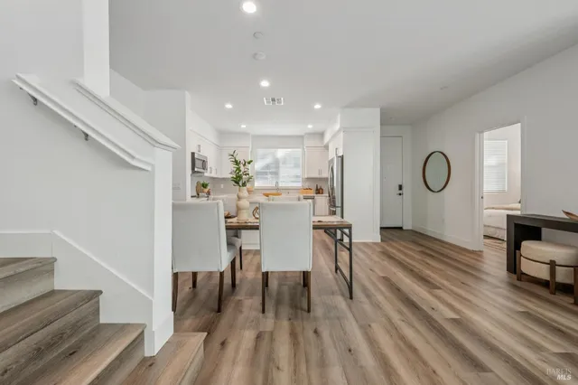 a view of a room with furniture and wooden floor