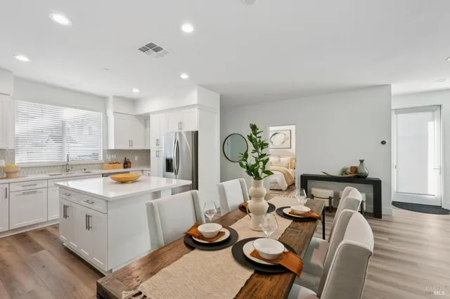 a open dining room with furniture and wooden floor