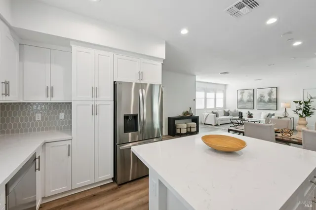 a kitchen with sink refrigerator and cabinets