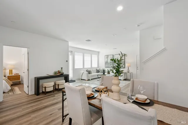 a living room with furniture flowerpot and wooden floor