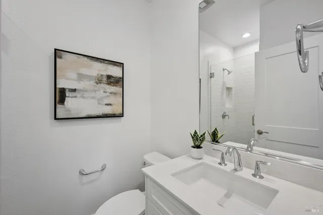 a bathroom with a sink mirror and toilet