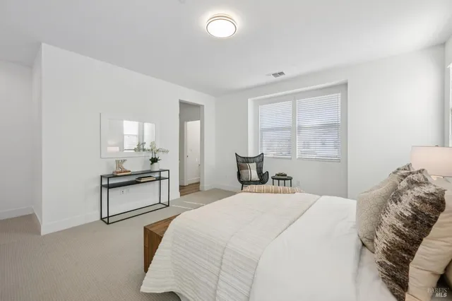 a bedroom with a bed and a chair