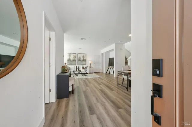 a view of a living room with furniture and a mirror