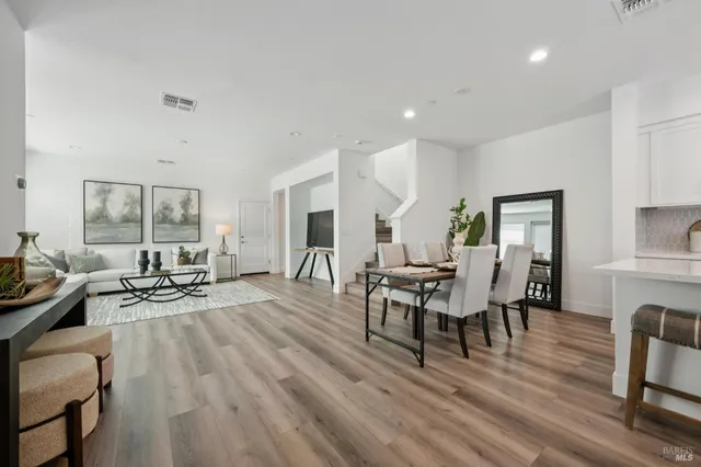 a living room with furniture a wooden floor and a fireplace