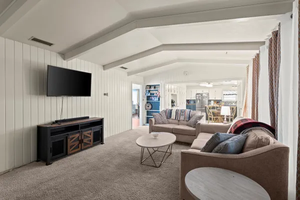 a kitchen with stainless steel appliances granite countertop a stove top oven a sink dishwasher and cabinets with wooden floor