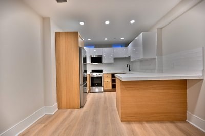 18 Winchester Street, Unit 2 Boston, MA 02116 - Photo 3 of 13 a kitchen with stainless steel appliances granite countertop a refrigerator a sink and a stove with wooden floor