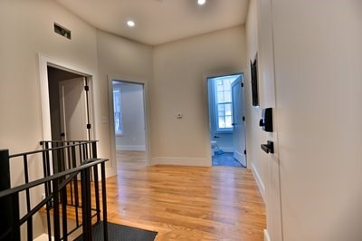 18 Winchester Street, Unit 2 Boston, MA 02116 - Photo 6 of 13 a view of a hallway with wooden floor and staircase
