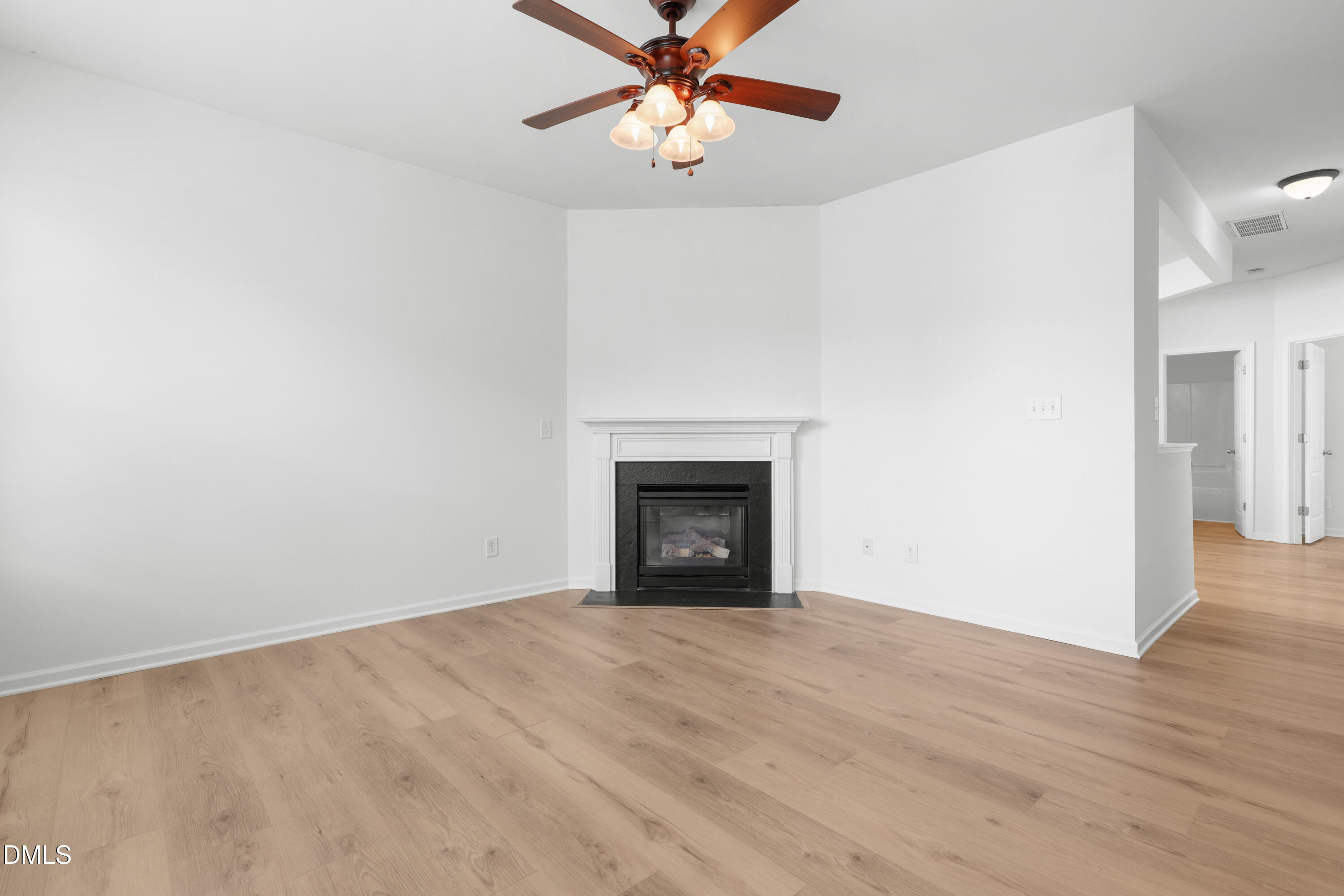 4400 Hillsgrove Road Wake Forest, NC 27587 - Photo 13 of 49 a view of an empty room with window and wooden floor