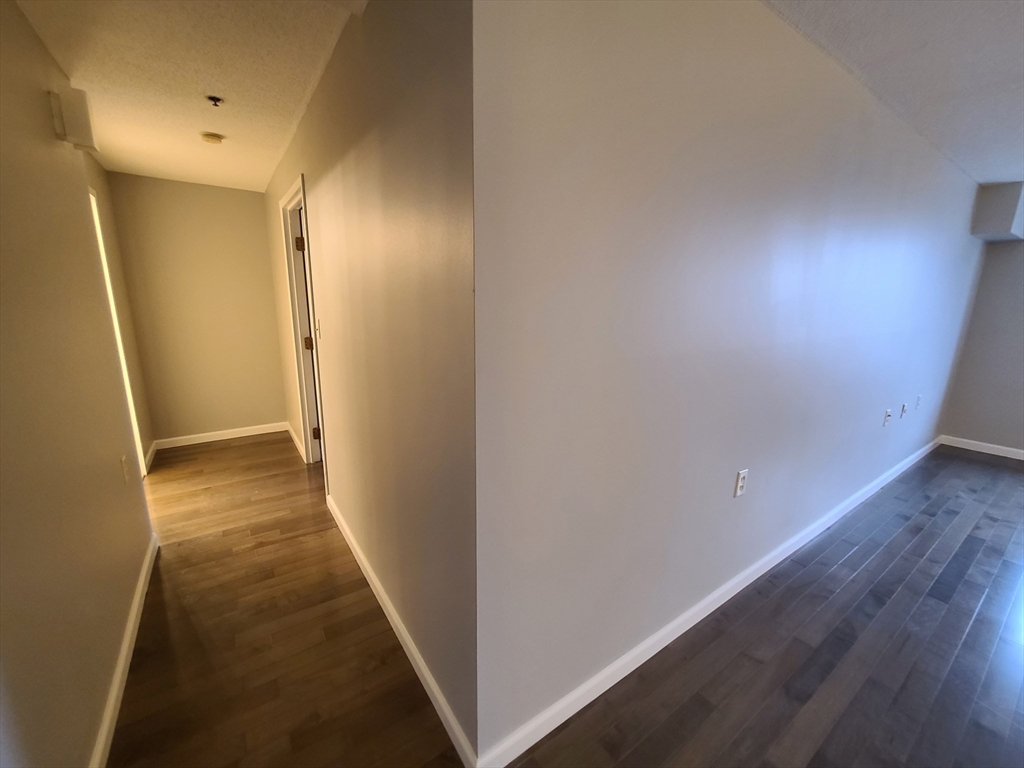 357 Commercial Street, Unit 507 Boston, MA 02109 - Photo 11 of 22 a view of a hallway with wooden floor