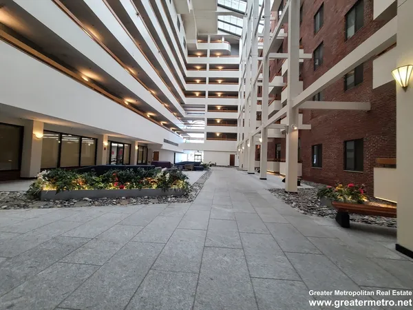a lobby with furniture and potted plants