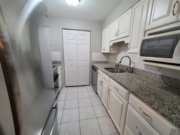 a kitchen with a sink stove and cabinets