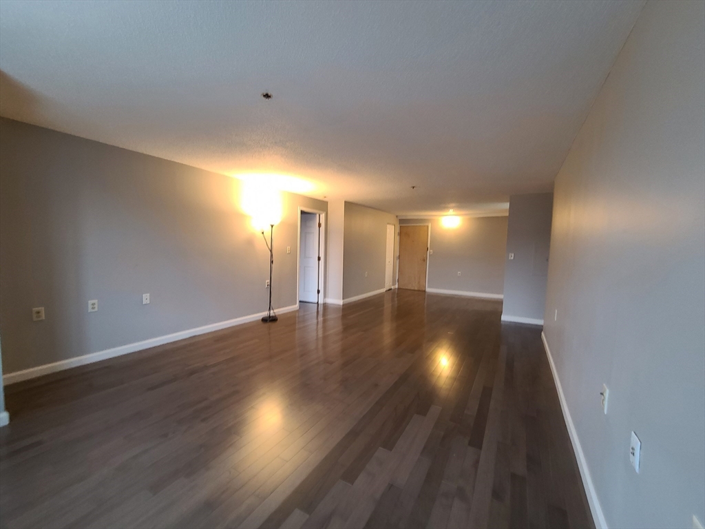 357 Commercial Street, Unit 507 Boston, MA 02109 - Photo 8 of 22 a view of an empty room with wooden floor