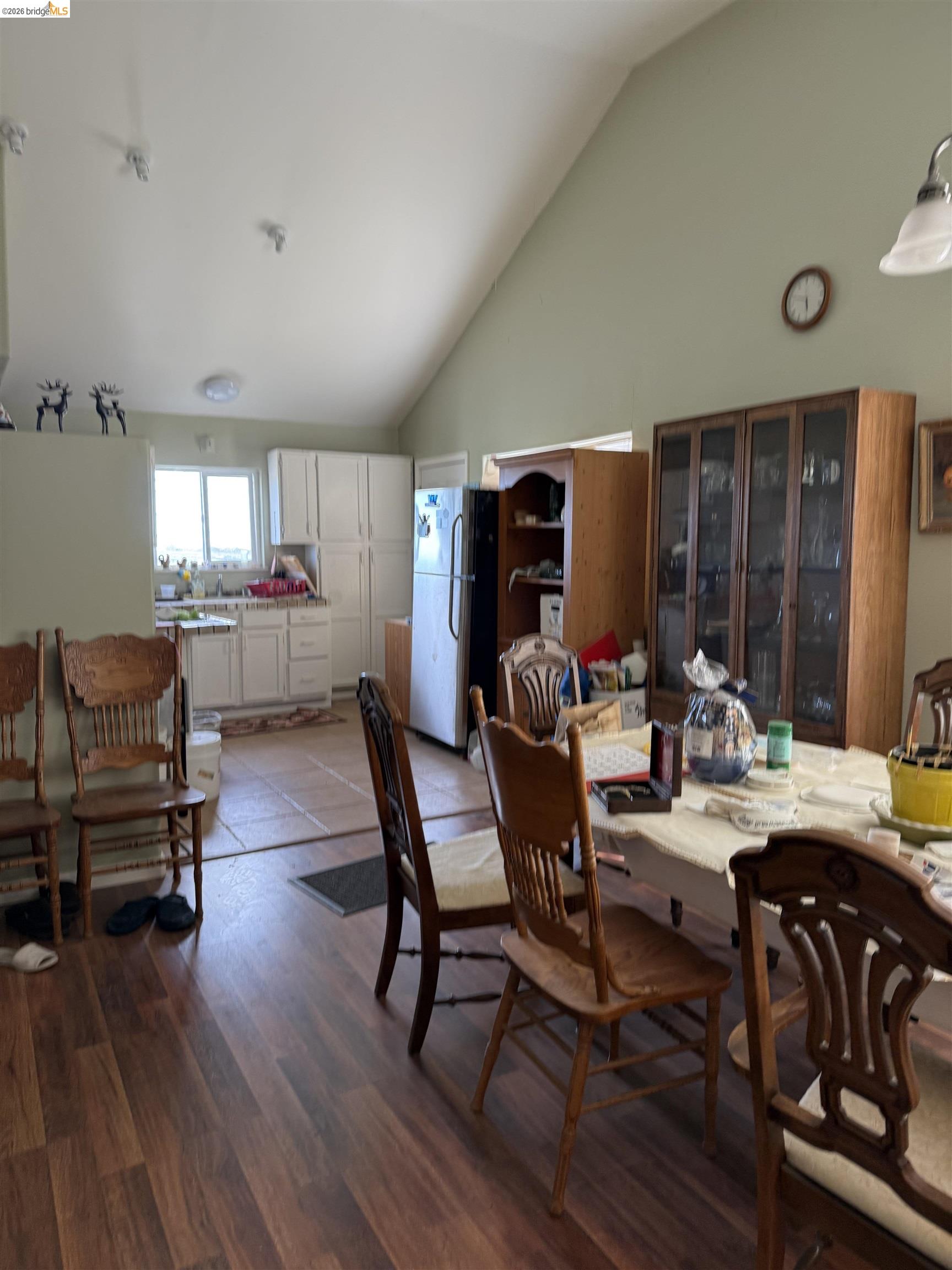 3678 Stone Road Bethel Island, CA 94511 - Photo 1 of 1 Dining space featuring vaulted ceiling and dark wood-type flooring