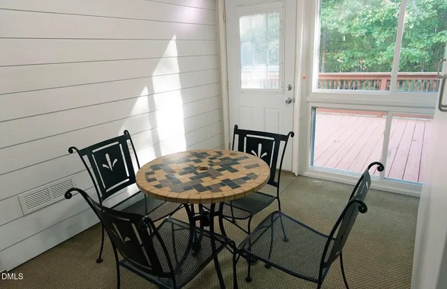 a view of a dining room with furniture and window