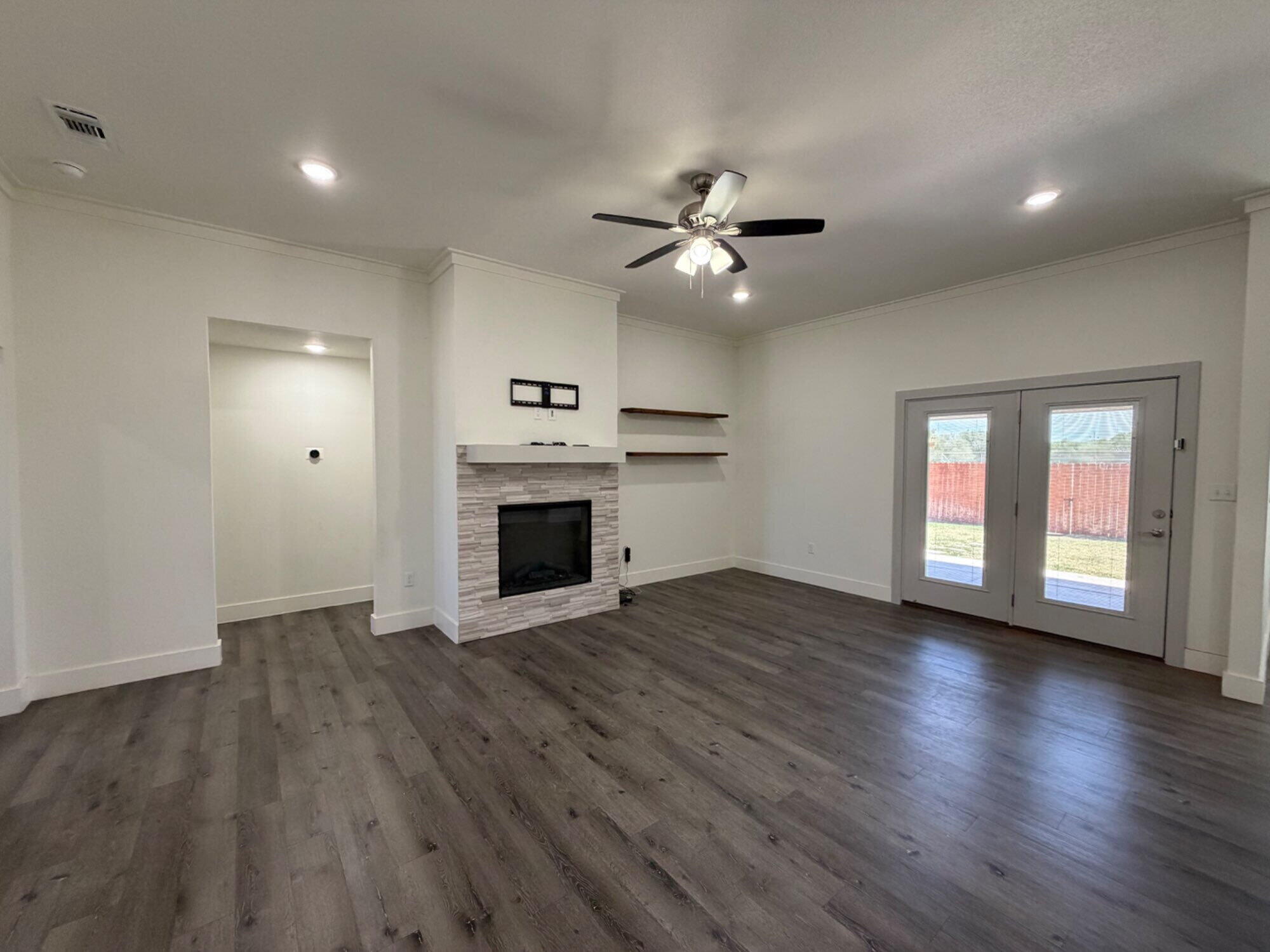 405 Ranger Street Wolfforth, TX 79382 - Photo 5 of 19 a view of empty room with wooden floor and fan