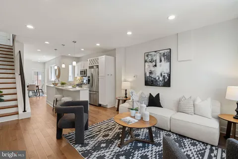 a living room with furniture and kitchen view