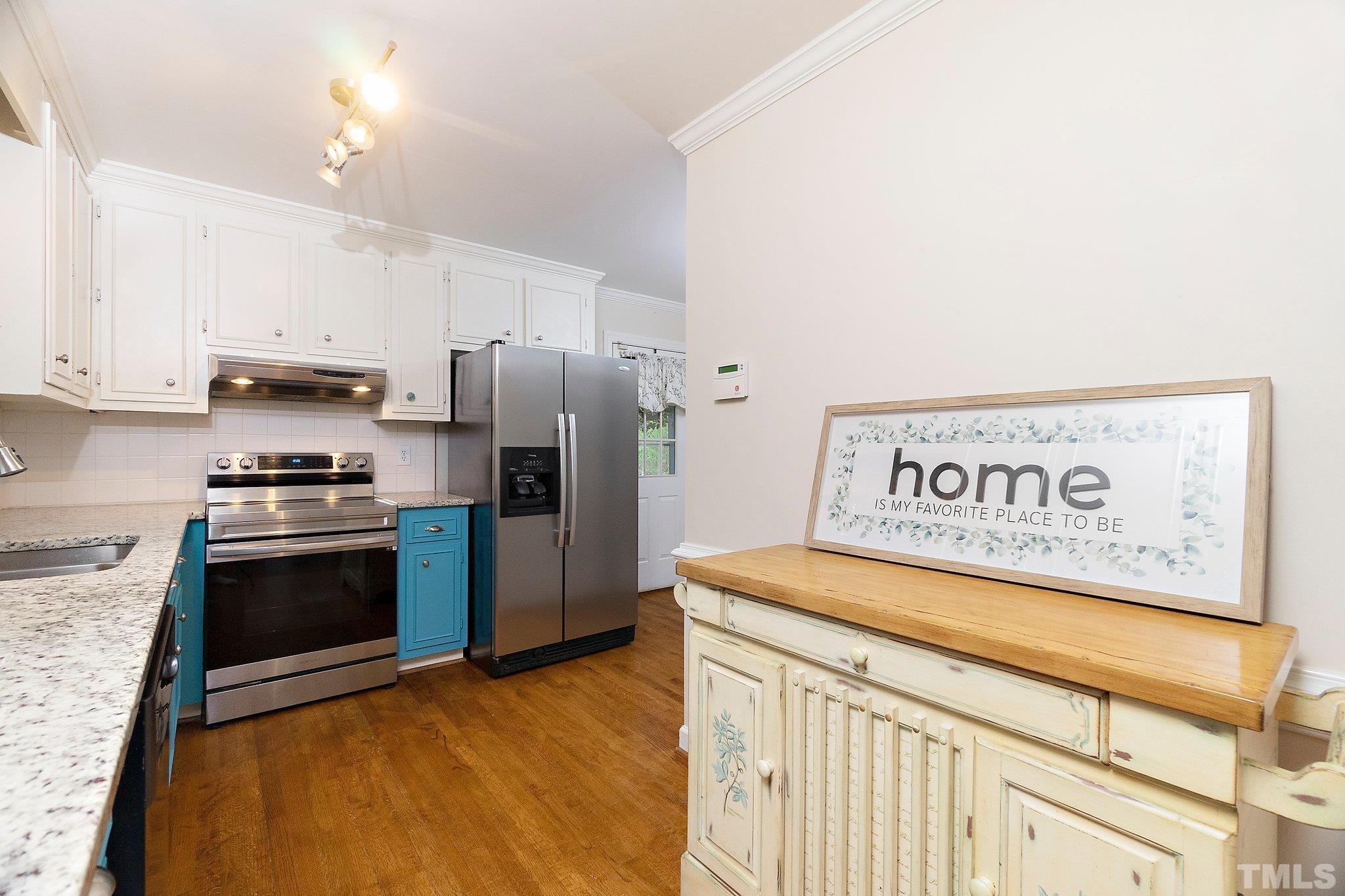 612 Morningside Drive Durham, NC 27713 - Photo 16 of 36 a kitchen with stainless steel appliances granite countertop a refrigerator a stove and a sink