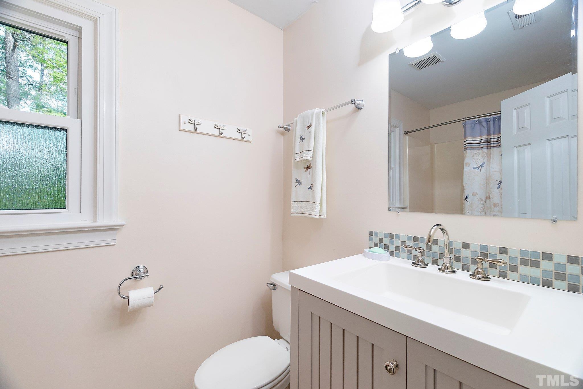612 Morningside Drive Durham, NC 27713 - Photo 23 of 36 a bathroom with a sink vanity granite and toilet