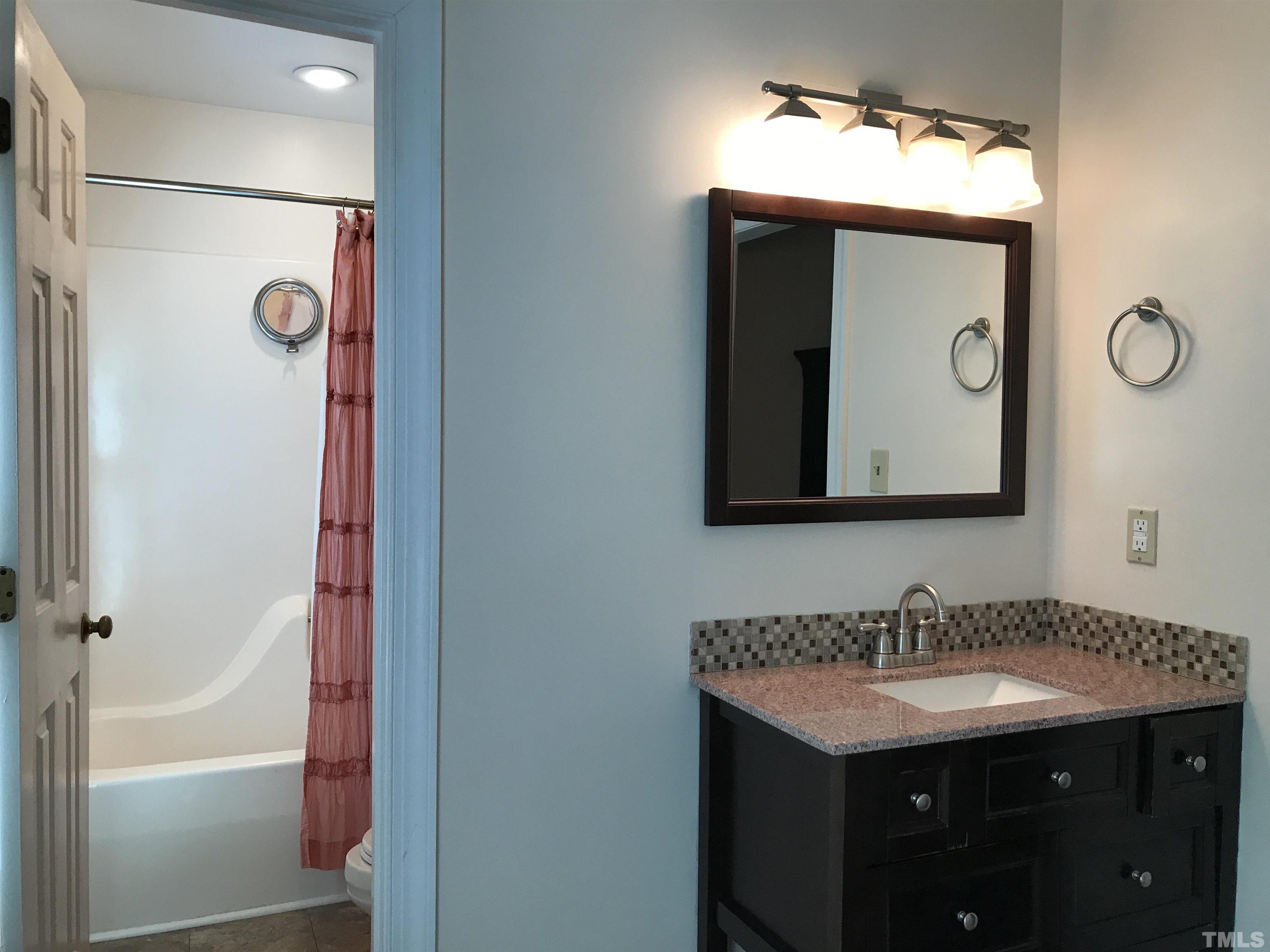 612 Morningside Drive Durham, NC 27713 - Photo 28 of 36 a bathroom with a sink vanity and a mirror