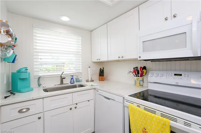 a kitchen with a sink cabinets and a stove