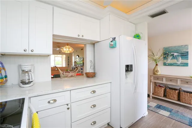 a kitchen with stainless steel appliances a refrigerator and cabinets