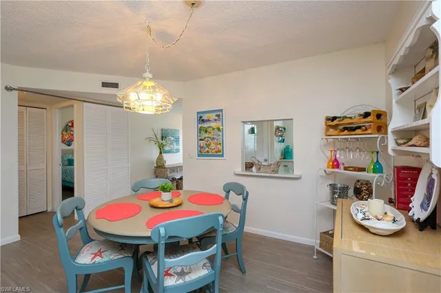 a view of a dining room with furniture and chandelier