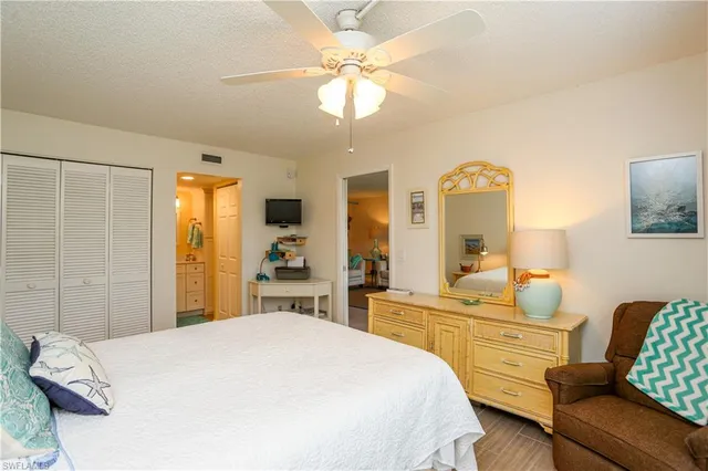 a bedroom with a bed couch and a window