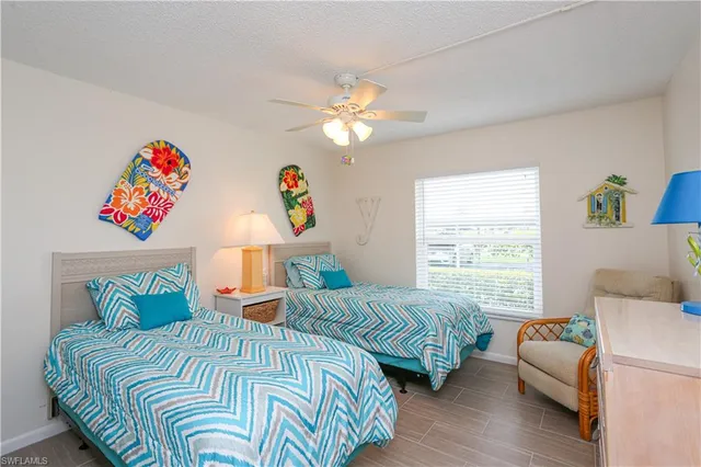 a bedroom with two beds and a window