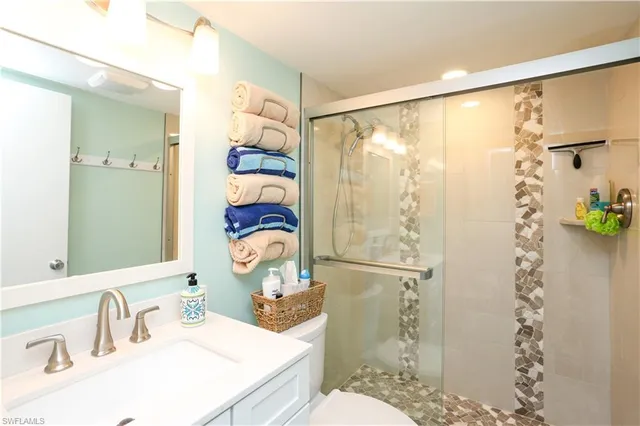 a bathroom with a sink toilet and shower