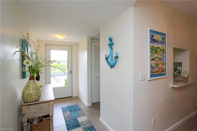 a view of an entryway with wooden floor