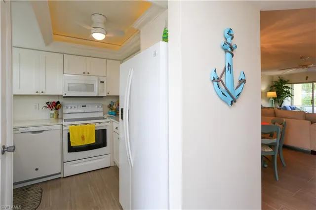 a kitchen with a refrigerator a stove and a window