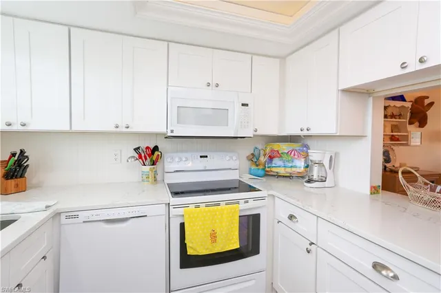 a view of a kitchen with sink and cabinets