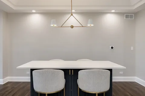 a view of a room with furniture and wooden floor