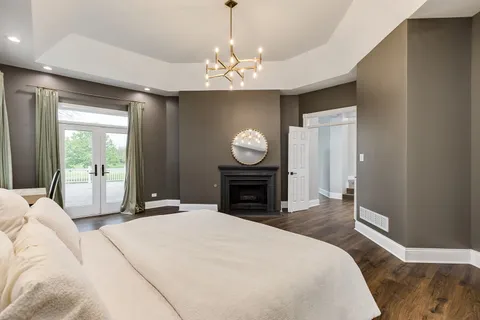 a spacious bedroom with a bed and a chandelier