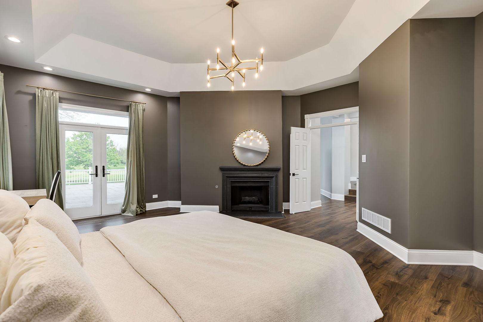 7 Loblolly Court Lemont, IL 60439 - Photo 21 of 45 a spacious bedroom with a bed and a chandelier